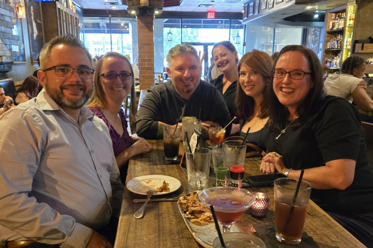 Sarah with a group of friends at a restaurant
