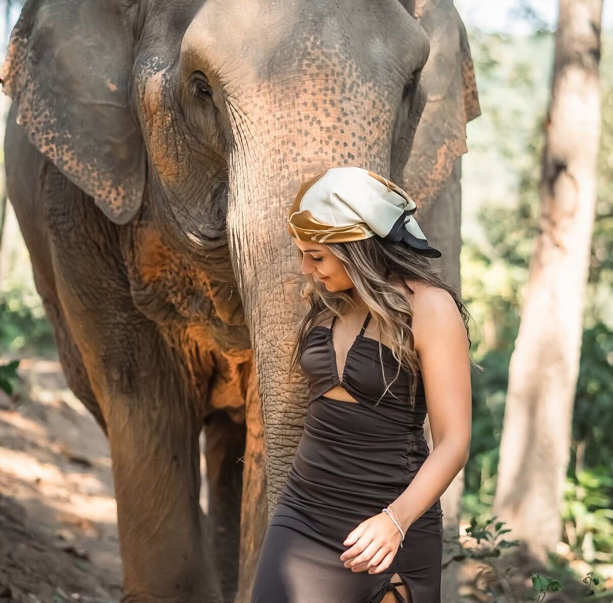 Sam shares a sweet moment with an Asian elephant during a trip to Thailand